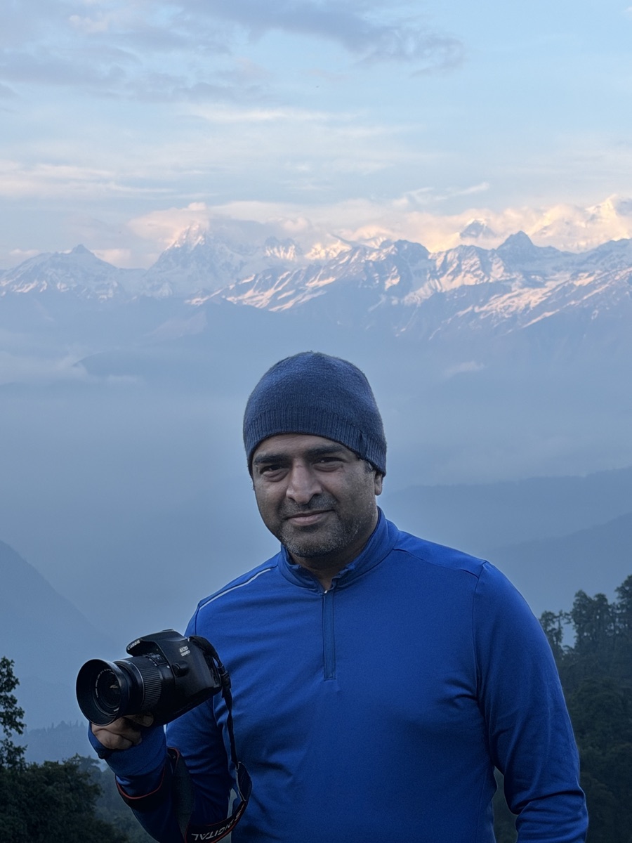 Portrait of Gaurav holding a camera on the Dayara Bugyal trek