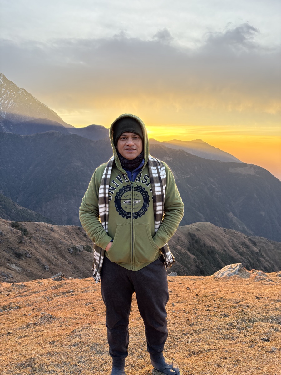 Portrait of Amit on the Laka Glacier trek with the sunset behind him