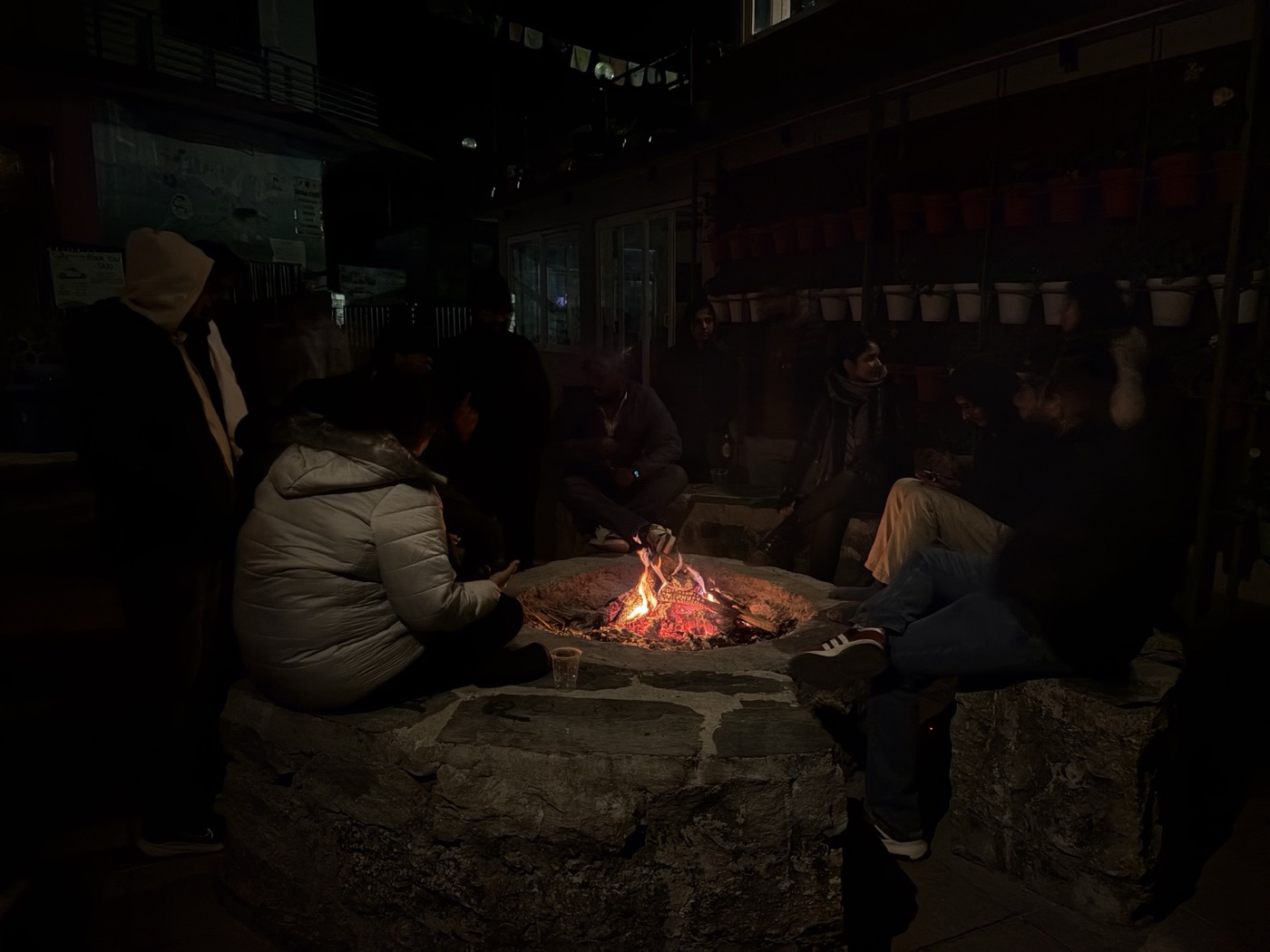 Friends and fellow travellers sitting around the Zostel bonfire in Dharamkot